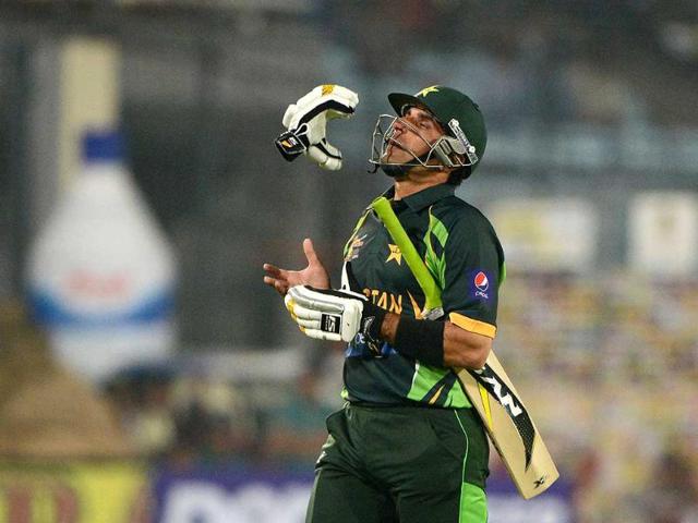 Pakistan captain Misbah-ul-Haq tosses his gloves as he walks off the field after losing his wicket during the sixth match of the Asia Cupagainst India and Pakistan at the Sher-e-Bangla National Cricket Stadium in Mirpur. (AFP Photo) 