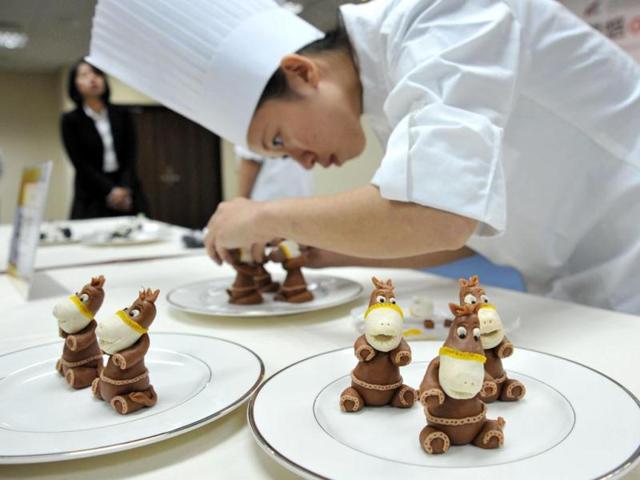 Contestants of The International Union of Bakers and Confectioners (UIBC) Junior World Pastry Championship 2014 pose in Taipei. (AFP)