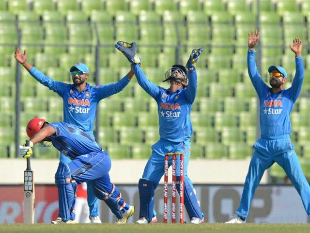 Dinesh Karthik, Virat Kohli and Ravindra Jadeja appeal for the dismissal of Afghan batsman Samiullah Shenwari during the ninth match of the Asia Cup at the Sher-e-Bangla National Cricket Stadium in Dhaka. (AFP Photo) Dinesh Karthik, Virat Kohli and Ravindra Jadeja appeal for the dismissal of Afghan batsman Samiullah Shenwari during the ninth match of the Asia Cup at the Sher-e-Bangla National Cricket Stadium in Dhaka. (AFP Photo)