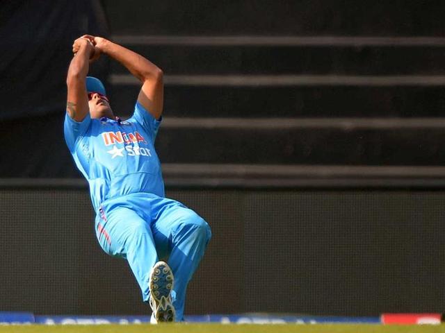 Stuart Binny takes a catch to dismiss Afghanistan batsman Najibullah Zadran during the ninth match of the Asia Cup 214 against Afghanistan in Mirpur. (AFP Photo)