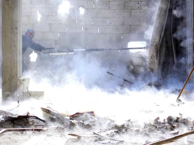 A Free Syrian Army fighter fires a weapon in eastern al-Ghouta, near Damascus. (Reuters Photo) A Free Syrian Army fighter fires a weapon in eastern al-Ghouta, near Damascus. (Reuters Photo)