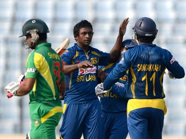 Sri Lankan cricketer Ajantha Mendis (C) celebrates with his teammate Kumar Sangakkara (R) after the dismissal of Bangladeshi batsman Shamsur Rahman during the tenth match of the Asia Cup at the Sher-e-Bangla National Cricket Stadium in Mirpur. (AFP Photo)