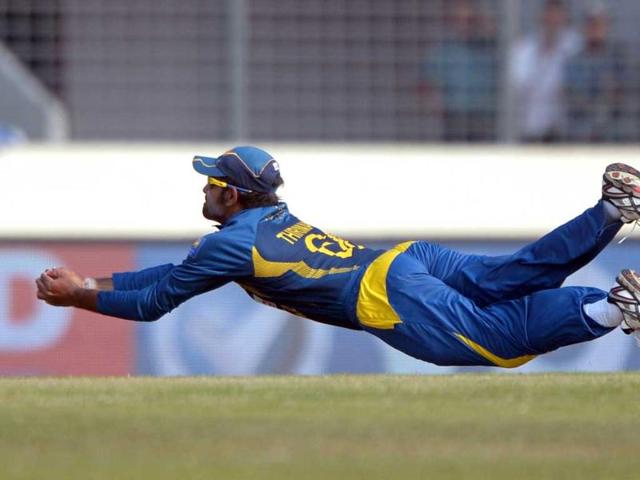 Sri Lankan fielder Lahiru Thirimanne dives to take the catch of Bangladeshi batsman Anamul Haque during the tenth match of the Asia Cup at the Sher-e-Bangla National Cricket Stadium in Mirpur. (AFP Photo)