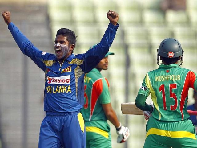 Sri Lanka’s Chaturanga de Silva (L) celebrates taking the wicket of Bangladesh’s Mushfiqur Rahim during their Asia Cup match in Mirpur. (AP Photo)