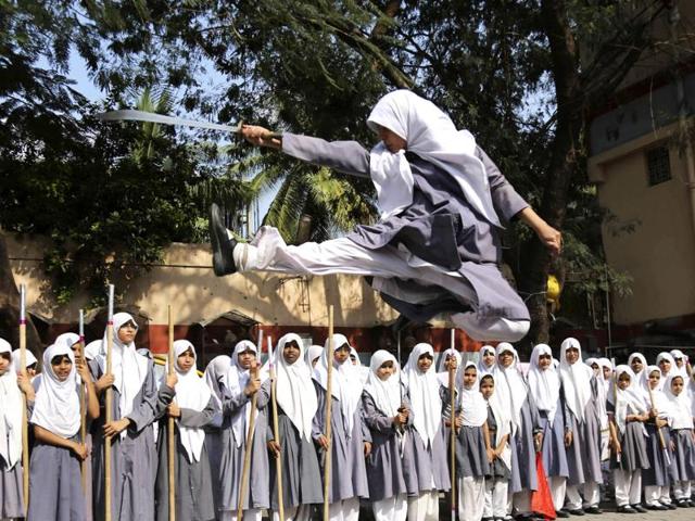 A muslim girl performs martial arts during a function to mark International Women’s Day at a school in Hyderabad. (AP photo)