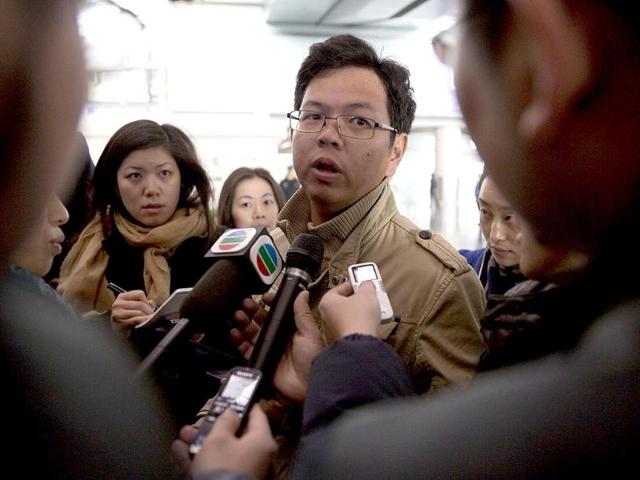A Malaysian man who says he has relatives on board the missing Malaysian Airlines plane, talks to journalists at Beijing's International Airport Beijing, China. (AP Photo)