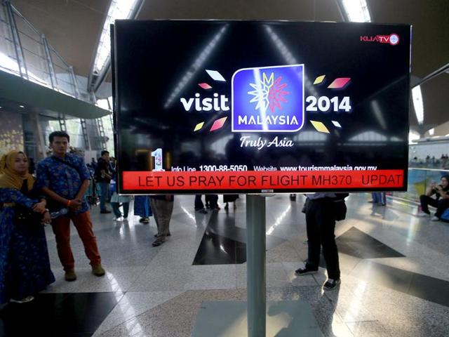 An information screen displays a message 'Let Us Pray For Flight MH370', regarding the missing Malaysia Airlines flight, at Kuala Lumpur International Airport. (Reuters)