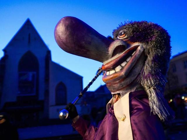 Revellers parade pull a lantern during the traditional Morgestreich procession starting the carnival of Basel. (AFP photo)