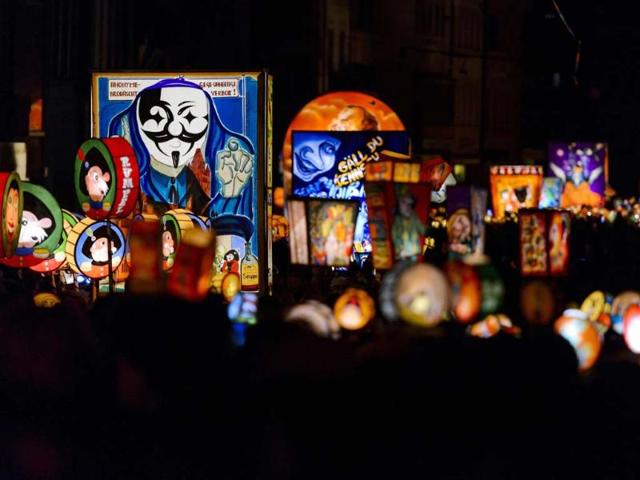 Revellers parade pull a lantern during the traditional Morgestreich procession starting the carnival of Basel. (AFP photo)