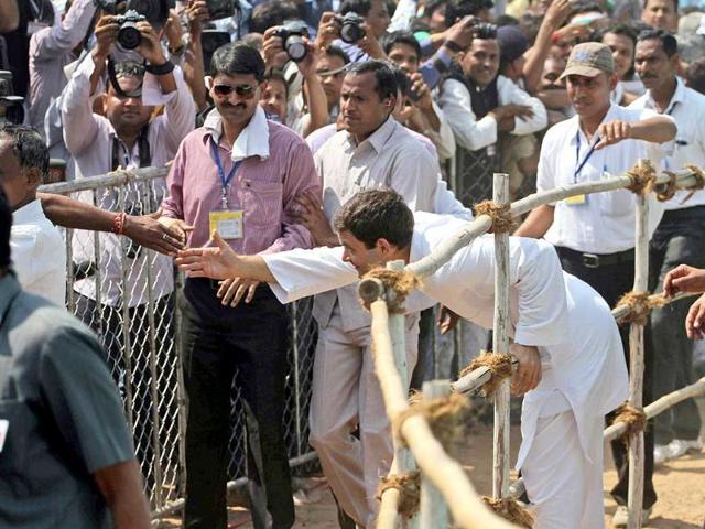 Congress party vice-president Rahul Gandhi, right, stretches out to greet a supporter during an election rally at Balasinor, Gujarat. (AP Photo)
