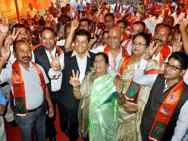 Assam BJP chief, Sarbananda Sonowal Assam (3rd L) and Bijoya Chakraborty (C), MP, with newly joined party members in Guwahati (PTI photo)