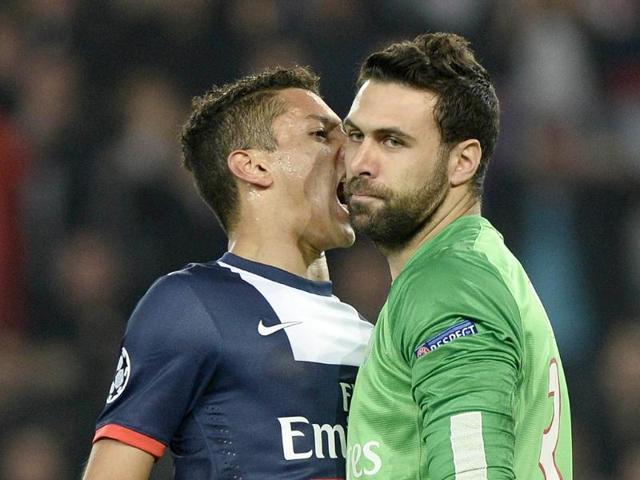 Paris' Brazilian defender Marquinhos celebrates after Paris' Italian goalkeeper Salvatore Sirigu (R) stopped a penalty during the UEFA Champions League last 16 second-leg football match between Paris Saint Germain and Bayer Leverkusen in Paris. (AFP photo)