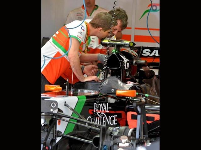 Sahara-Force-India-mechanics-prepare-the-car-of-Sercio-P-rez-of-Mexico-ahead-of-the-Formula-One-Australian-Grand-Prix-in-Melbourne-AFP-Photo