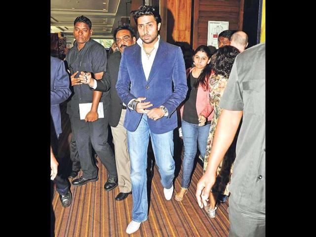 Abhishek Bachchan, surrounded by security, walks into an event in Mumbai.