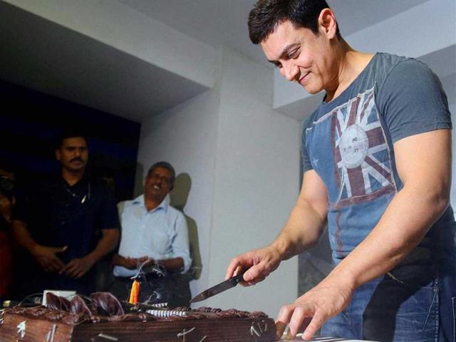 Aamir Khan celebrates his 49th birthday at his home in Mumbai. (PTI Photo)