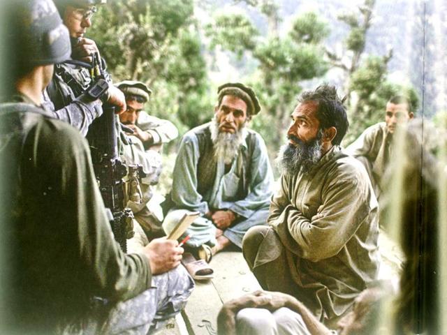 September 2009: US soldiers question a family about Taliban presence in the Shuryak Valley in Kunar province. (Robert Nickelsberg)
