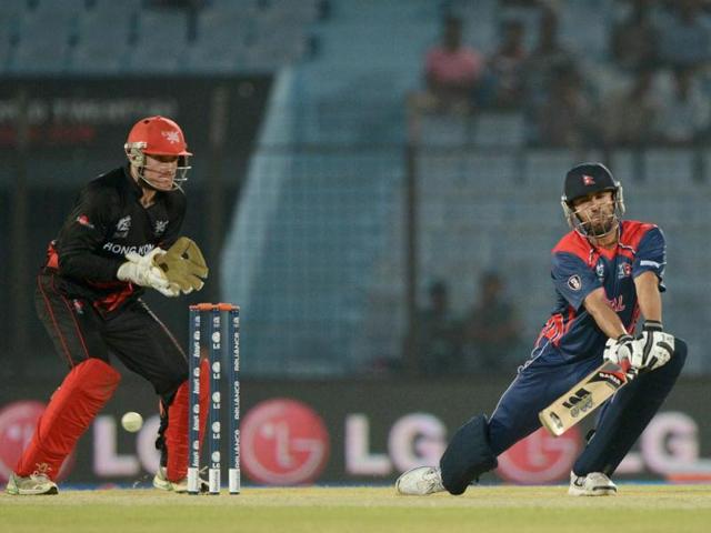 Nepal's Sharad Vesawkar (R) plays a shot as Hong Kong's Jamie Atkinson (L) looks on during their ICC World T20 match in Chittagong. (AFP Photo)