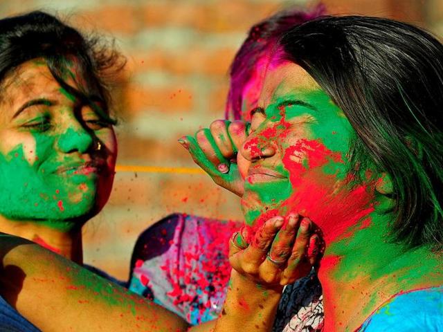 Girls play with colours during Holi celebrations. (Agencies)