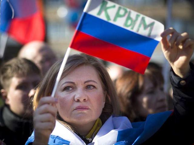 Cossacks-hold-Russian-and-Crimean-flags-during-a-rally-marking-the-one-year-anniversary-of-Crimea-voting-to-leave-Ukraine-and-join-the-Russian-state-in-central-Simferopol-AFP-photo