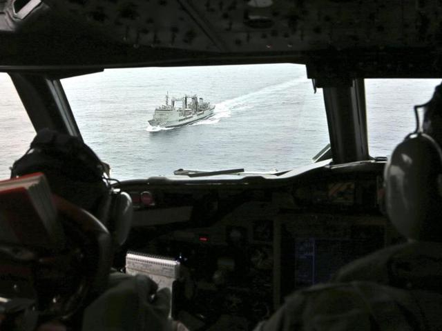 Flight Lieutenant Jason Nichols aboard a Royal Australian Air Force (RAAF) AP-3C Orion, looks ahead towards the Australian navy ship HMAS Success as they search for missing Malaysian Airlines flight MH370 over the southern Indian Ocean. (Reuters)