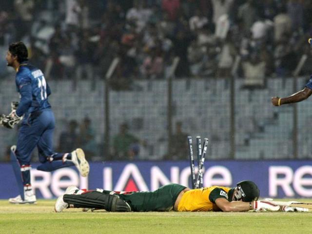 South Africa's David Miller lies on the ground after failing to reach the crease, as Sri Lankan cricketers celebrate during their ICC World Twenty20 match in Chittagong. (AP Photo) South Africa's David Miller lies on the ground after failing to reach the crease, as Sri Lankan cricketers celebrate during their ICC World Twenty20 match in Chittagong. (AP Photo)