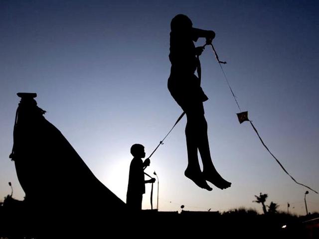 Two boys are silhouetted as they fly a kite on the Marina beach in the southern Indian city of Chennai. Reuters/Babu