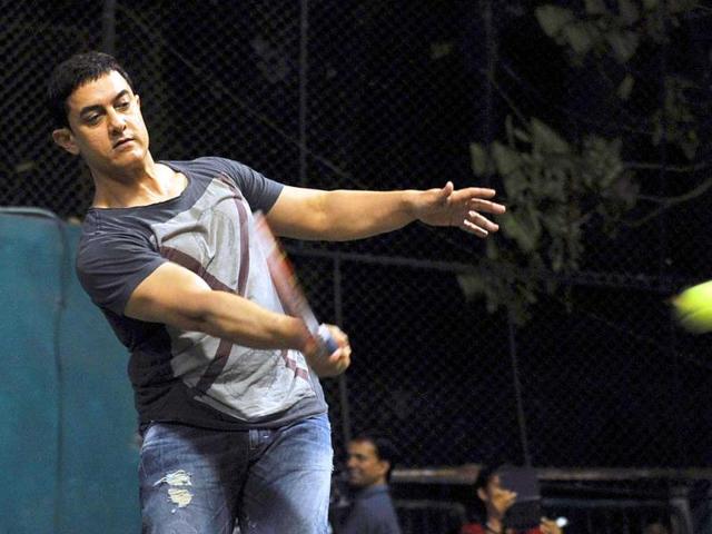 Aamir Khan plays during All India Women's Open Tennis Tournament 2014 in Mumbai on Sunday. (PTI Photo)