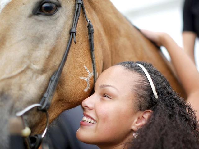 Precious Perez hugs a horse from Cavalia's Odysseo show during a blind touch tour arranged by the show with the Carroll Center for the Blind in Somerville, Massachusetts. (Reuters photo) Precious Perez hugs a horse from Cavalia's Odysseo show during a blind touch tour arranged by the show with the Carroll Center for the Blind in Somerville, Massachusetts. (Reuters photo)
