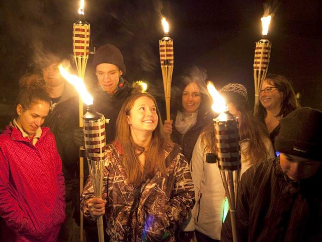 Students and visitors hold torches as they observe Earth Hour outside Fleming College's Frost Campus for Environmental Studies in Lindsay, Ontario. (Reuters)