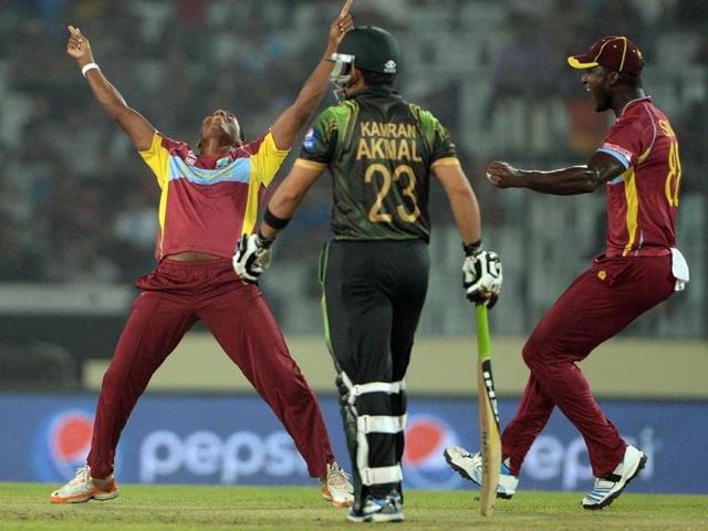 West Indies' Krishmar Santokie (L) celebrates the wicket of Pakistan's Ahmed Shehzad during their ICC World Twenty20 match at the Sher-e-Bangla National Cricket Stadium in Dhaka. (AFP Photo) 
