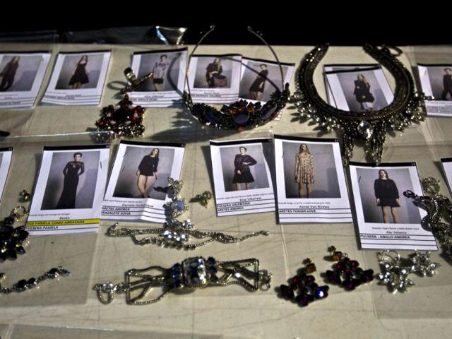 Photographs of outfits and jewelry sit backstage during Mexican Fashion Week in Mexico City. (AP)