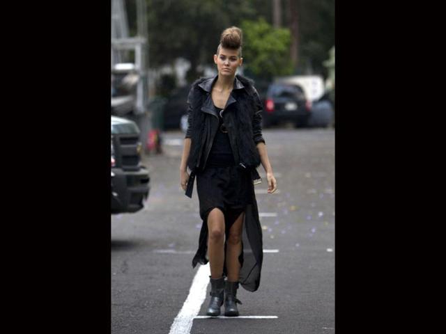 A model walks in the parking lot after being dressed for the cat walk as she returns backstage at Mexican Fashion Week in Mexico City. (AP)