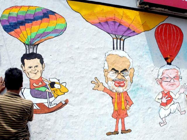 Trinamool Congress workers making a graffiti ahead of Lok Sabha elections near the residence of party supremo and West Bengal chief minister Mamata Banerjee, in Kolkata. (PTI Photo)