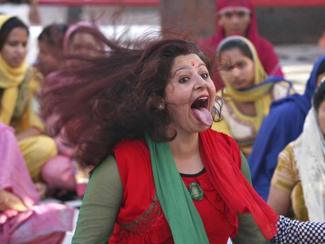 A female devotee gets into a trance during a ritual inside a temple on the fourth day of the nine-day long Navratri festival on the outskirts of Jammu. (Reuters Photo)