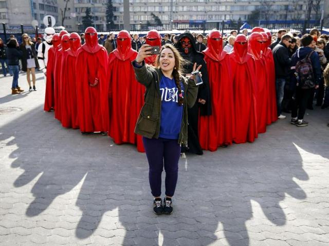 The look-there's-something-cool-happening-behind-me selfie - She's standing in front activists from the Internet Party of Ukraine during a rally. And there party leader is called Darth Vader. Beat that. (Reuters Photo)