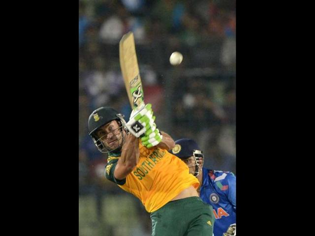 South Africa's Faf du Plessis (L) plays a shot as MS Dhoni (R) looks on during their ICC World Twenty20 match in the Sher-e-Bangla National Cricket Stadium in Dhaka. (AFP Photo)