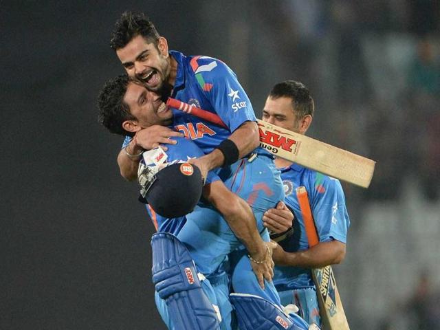Yuvraj Singh picks up Virat Kohli (2R) after India won the ICC World Twenty20 match against South Africa at the Sher-e-Bangla National Cricket Stadium in Dhaka. (AFP Photo)