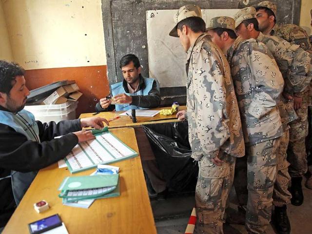 Afghan security personnel line up for the registration process before they cast their votes at a polling station in Kabul, Afghanistan. (AP Photo)