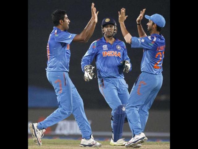 Ravichandran Ashwin (L) celebrates with MS Dhoni (C) and Ajinkya Rahane (R) the wicket of Sri Lanka's Tillakaratne Dilshan during their ICC WOrld Twenty20 match in Dhaka. (AP Photo)