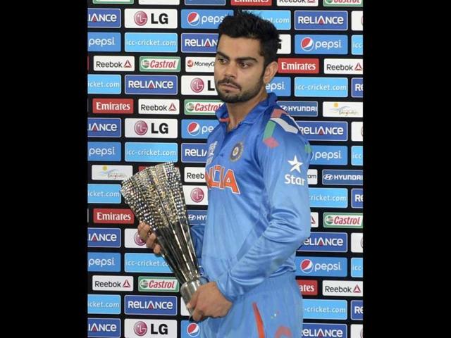 Virat Kohli poses with the Man of the Series trophy following the ICC World Twenty20 final match against Sri Lanka at the Sher-e-Bangla National Cricket Stadium in Dhaka. (AFP Photo)