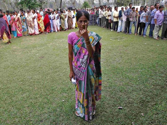 A-woman-shows-her-ink-marked-finger-after-casting-her-vote-as-others-line-up-to-cast-their-ballot-at-a-polling-station-in-Nakhrai-village-in-Tinsukia-district-Assam-Reuters-Photo A-woman-shows-her-ink-marked-finger-after-casting-her-vote-as-others-line-up-to-cast-their-ballot-at-a-polling-station-in-Nakhrai-village-in-Tinsukia-district-Assam-Reuters-Photo