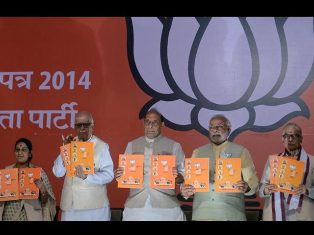 BJP-s-PM-nominee-Narendra-Modi-poses-alongisde-BJP-president-Rajnath-Singh-LK-Advani-Sushma-Swaraj-and-Murli-Manohar-Joshi-as-they-hold-up-the-party-manifesto-upon-its-release-in-New-Delhi-AFP-photo