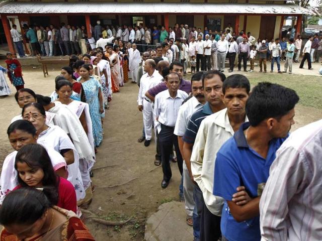 Voters line up to cast their vote outside a polling station in Nakhrai village in Tinsukia district in Assam. (Reuters photo)