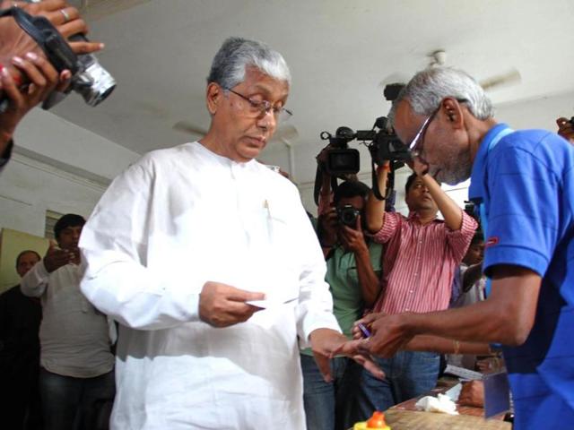 Tripura CM Manik Sarkar gets his finger marked with ink by an election official as he votes at a polling station in Agartala, Tripura. (AFP photo)