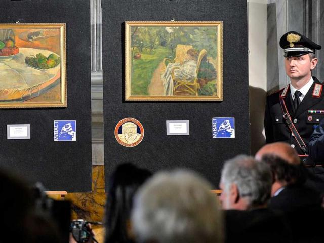 A-Carabinieri-stands-next-to-the-two-paintings-stolen-in-London-in-the-1970s-by-French-artists-Paul-Gauguin-Fruits-sur-une-table-ou-nature-morte-au-petit-chien-L-and-Pierre-Bonnard-La-femme-aux-deux-fauteuils-AFP A-Carabinieri-stands-next-to-the-two-paintings-stolen-in-London-in-the-1970s-by-French-artists-Paul-Gauguin-Fruits-sur-une-table-ou-nature-morte-au-petit-chien-L-and-Pierre-Bonnard-La-femme-aux-deux-fauteuils-AFP