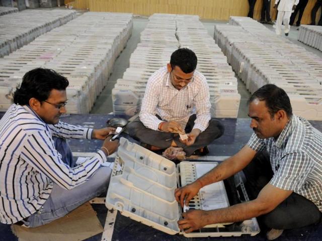 Election officials checking electronic voting machines to be used for the forthcoming Lok Sabha polls in Gurgaon. (Parveen Kumar/HT photo)