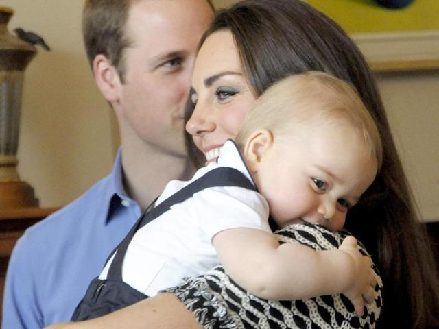 Prince George is held by his mother, Catherine, the Duchess of Cambridge, as Prince William looks on, during a Plunket nurse and parents group visit at Government House in Wellington. (AFP photo)