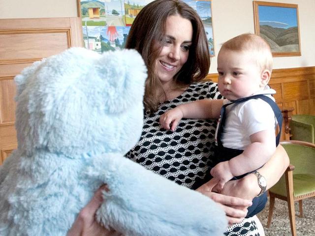 Prince George plays with a large soft bear during a visit to the Plunket nurse and parents group in Wellington. (AFP photo)