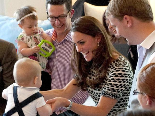 Prince George plays with his mother during a visit to the Plunket nurse and parents group in Wellington. (AFP photo)