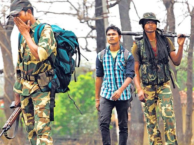 Raoji-Naitam-walks-with-security-personnel-in-Gadchiroli-Anshuman-Poyrekar-HT-Photo Raoji-Naitam-walks-with-security-personnel-in-Gadchiroli-Anshuman-Poyrekar-HT-Photo
